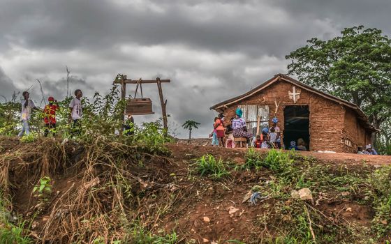 People outside a Catholic church in a village in Malanje Province, Angola, in 2018 (Dreamstime/Nuno Almedia)