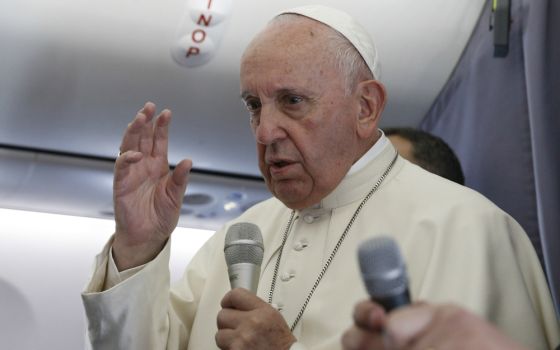 Pope Francis answers questions from journalists aboard his flight from Sibiu, Romania, to Rome June 2. (CNS/Paul Haring)