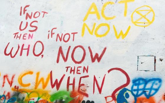 Wall painting that says "If not us, then who, if not now, then when?" (Unsplash/Rod Long)