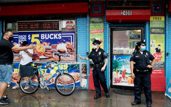 Camden County Police Officers Alexander Baldwin and Natalie Perez patrol on the streets of Camden, New Jersey, June 11. (Newscom/Reuters/Jessica Kourkounis)