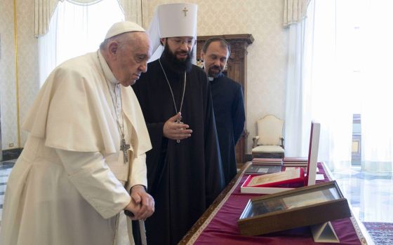 Pope Francis exchanges gifts with Metropolitan Anthony of Volokolamsk, head of external relations for the Russian Orthodox Church, during a meeting at the Vatican Aug. 5, 2022.