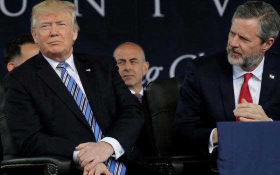 President Trump, left, sits before delivering the keynote address at Liberty University’s commencement in Lynchburg, Va., on May 13, 2017. Seated on the right is Liberty University President Jerry Falwell Jr. (Yuri Gripas/Reuters)
