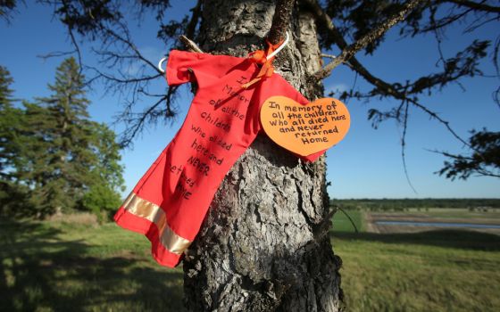 An offering is seen at the site of the former Brandon Indian Residential School June 12, 2021. Researchers — partnered with the Sioux Valley Dakota Nation — located 104 potential graves at the site in Brandon, Manitoba. (CNS/Reuters/Shannon VanRaes)