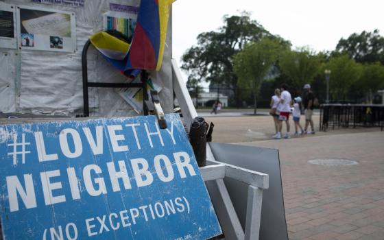 A "Love Thy Neighbor: No Exceptions" sign is seen near the White House in Washington July 7. (CNS/Tyler Orsburn)