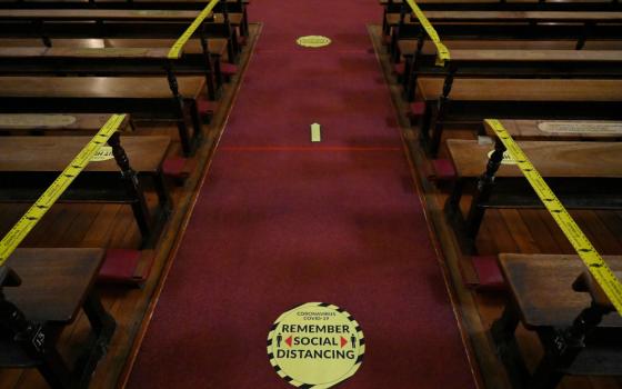 Pews are taped off and social distancing markers are pictured at the Church of Mary Immaculate Refuge of Sinners during Mass in Dublin Feb. 17, 2021, during the COVID-19 pandemic. (CNS/Reuters/Clodagh Kilcoyne)