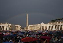 A rainbow is seen as Pope Francis attends a meeting with Catholic charismatics in St. Peter's Square July 3, 2015, at the Vatican. (CNS/Paul Haring)