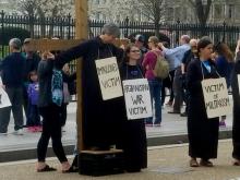 Faith and Resistance retreatants participate in a Good Friday public witness in front of the White House in Washington, D.C., March 30 to protest "contemporary crucifixion." (Lin Romano)