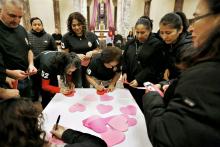 New citizens write their names on hearts to be displayed on the outside of St. Rita of Cascia Church in Bedford Park, Illinois, during a Pastoral Migratoria program March 30. (CNS/Chicago Catholic/Karen Callaway)