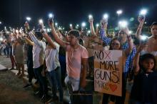 Mourners take part in a vigil near the border fence between Mexico and the U.S. after a mass shooting at a Walmart store in El Paso, Texas, Aug. 3. (CNS/Reuters/Carlos Sanchez)