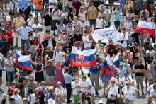 Pilgrims holding the Slovak flag cheer in St. Peter's Square at the Vatican July 4 as Pope Francis announces he will visit their country Sept. 12-15. (CNS/Vatican Media) 