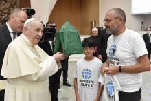 Pope Francis accepts the gift of a handmade "Abraham's tent" during his general audience in the Paul VI hall at the Vatican Sept. 1. The gift was given by members of the Laudato Si' Movement. (CNS/Vatican Media)