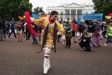 A Native American woman poses for pictures near the White House in Washington Oct. 11, 2021, as people demonstrate during a climate change protest on Columbus Day, also called Indigenous Peoples Day by activist groups. (CNS photo/Kevin Lamarque, Reuters)