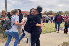 People in St. Louis embrace following a shooting at a high school Oct. 24. (CNS/NPR Midwest Newsroom via Reuters/Holly Edgell)