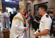 Archbishop Timothy Broglio of the U.S. Archdiocese for the Military Services greets a U.S. Naval Academy cadet midshipman after the annual Sea Services Pilgrimage Mass at the National Shrine of St. Elizabeth Ann Seton Oct. 2 in Emmitsburg, Maryland. (CNS/Courtesy of Devine Partners/Jason Minick)