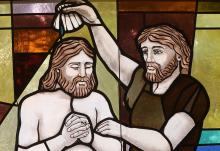 The baptism of Christ by John the Baptist is depicted in a stained-glass window at St. Anthony's Church July 15, 2021, in North Beach, Maryland. (CNS/Bob Roller)