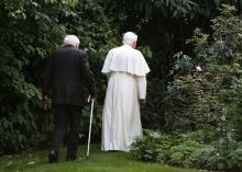 Pope Benedict and his brother walk in a park