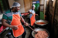 Chef Elijah Amoo Addo and cook Angel Laryea of Food for All Africa prepare free lunch to reduce food waste and feed those in need in Accra, Ghana, June 3, 2022. (CNS/Reuters/Francis Kokoroko)