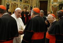 Pope Francis greets U.S. Cardinal Raymond Burke, patron of the Knights and Dames of Malta, during an audience to exchange Christmas greetings with members of the Roman Curia in Clementine Hall at the Vatican Dec. 22, 2014. (CNS/Paul Haring)