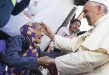 Pope Francis greets an elderly woman as he meets with people in a poor neighborhood in Asuncion, Paraguay, in this July 12, 2015, file photo. (CNS/Paul Haring)
