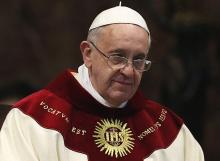 With the seal of the Society of Jesus on his vestments, Pope Francis celebrates Mass at the Jesuit Church of the Gesù in Rome Jan. 3, 2014. The Mass was celebrated on the feast of the Most Holy Name of Jesus in thanksgiving for the canonization of St. Peter Faber. (CNS/Paul Haring)