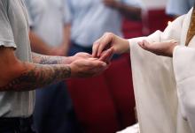 A file photo shows an inmate receiving Communion at the Ellsworth Correctional Facility in Kansas. (OSV News/CNS file/The Register/Karen Bonar)