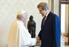 Pope Francis shakes hands with John Kerry, President Biden's special envoy for climate issues, during a meeting June 19 at the Vatican. (CNS/Vatican Media)