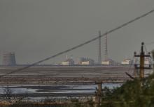The Zaporizhzhia Nuclear Power Plant, Europe's largest, is seen in the background of the shallow Kakhovka Reservoir after the dam collapse, in Energodar, Russian-occupied Ukraine, June 27. Ukraine and Russia accused each other Wednesday, July 5, of planning to attack the power plant, which is occupied by Russian troops, but neither side provided evidence to support their claims. (AP photo/Libkos, File)