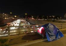A tarp covers a portion of a homeless person's tent on a bridge overlooking the 101 Freeway Feb. 2 in Los Angeles. A study of homelessness in California released in June found that "a quarter (24%) of participants noted they could not find housing that meets their needs due to a physical disability; 14% indicated that this impacted their ability to find housing a lot." (AP photo/Jae C. Hong, File)