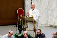 Dominican Fr. Timothy Radcliffe stands at lectern and speaks into mic.