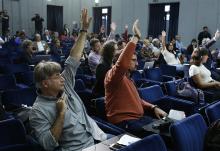 Reporters raise their hands to ask questions during a news conference after a session of the Synod of Bishops for the Amazon at the Vatican Oct. 22, 2019. (CNS/Paul Haring)