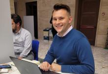 NCR Vatican correspondent Christopher White at work during the synod on synodality in Rome in October (NCR photo)