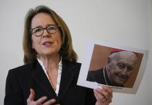 Anne Barrett Doyle, co-director of BishopAccountability.org, holds a photo of ex-Cardinal Theodore McCarrick during a press conference in Rome, Monday, Feb. 17, 2020, on the occasion of the first anniversary of Pope Francis' summit on clergy abuse. (AP/Andrew Medichini)