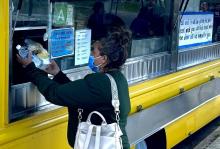 A guest receives lunch from the Feed My Poor food truck in MacArthur Park, just west of downtown Los Angeles.