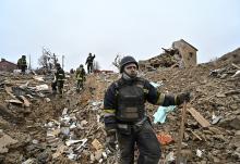 A first responder works at a site of residential buildings destroyed by a Russian airstrike in Zaporizhzhia, Ukraine, March 22, 2024. (OSV News/Reuters)