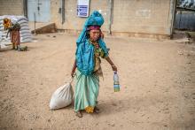 A woman carries home her rations of wheat, yellow split peas and cooking oil following a distribution of U.S. Agency for International Development (USAID) food in a rural area of Ethiopia's Oromia region Feb. 9, 2019. (OSV News/Courtesy of CRS/Will Baxter)