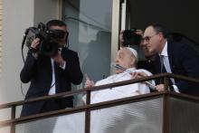 Pope Francis appears at a window of the Agostino Gemelli Polyclinic in Rome, Sunday, March 23, 2025, where he has been treated for bronchitis and bilateral pneumonia since Feb. 14. (AP Photo/Riccardo De Luca)