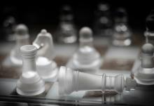A close-up of a chess board shows translucent pieces (Unsplash/Peter Law)