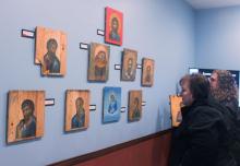 Attendees look at the "Icons on Ammo Boxes Exhibit," part of a fundraising event for Ukraine at Annunciation Byzantine Catholic Church in Homer Glen, Illinois, March 31. The event was sponsored by the parish, Rebuild Ukraine and CNEWA. (CNS/Laura Ieraci)