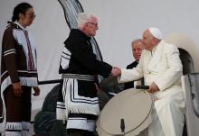 Elder Piita Irniq and youth drum dancer Malachai Angulalik Mala present Pope Francis with a traditional drum during a meeting with young people and elders outside the primary school in Iqaluit in the Canadian territory of Iqaluit, Nunavut, July 29. 