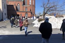 Parishioners walk on the snow-cleared parking lot of St. Patrick Church in Lawrence, Massachusetts, to assemble in winter for Mass outdoors. (Courtesy of St. Patrick Parish)