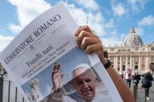 Free copies of the Vatican newspaper L'Osservatore Romano with the front page about Pope Francis' encyclical, " 'Fratelli Tutti,' on Fraternity and Social Friendship," are distributed by volunteers at the end of the Angelus in St. Peter's Square at the Va