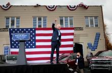 Democratic presidential nominee Joe Biden raises his arm during a drive-in campaign event in Toledo, Ohio, Oct. 12. (CNS//Reuters/Rebecca Cook)