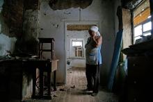 Katerina Izvekova, 77, inside her home damaged during a military conflict between militants of the self-proclaimed Donetsk People's Republic and the Ukrainian armed forces in late July (CNS/Reuters/Alexander Ermochenko)