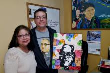 Many images of Blessed Archbishop Óscar Romero adorn the office of Tony Arteaga, shown here with his wife, Delmy, at Los Angeles’ Dolores Mission Parish. (NCR photo/Dan Morris-Young)