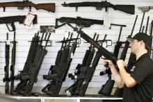 A salesman clears the chamber of an AR-15 in 2016 at a gun store in Provo, Utah. (CNS/Reuters/George Frey)