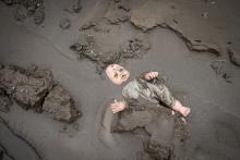 After hurricane Eta and Iota in 2020, a child's doll is stuck in the mud in a street in Chamelecón, San Pedro Sula, Honduras. Scientists say climate change is making storms like those more frequent and more severe. (Photo courtesy of Sean Hawkey, World Co