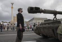 People visit an avenue where burned-out and captured Russian tanks and infantry carriers have been displayed in downtown Kyiv, Ukraine, Aug. 20. (AP/Andrew Kravchenko)