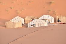 Tents in the desert (Unsplash/Oliver Schweizer)