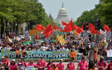 Demonstrators join the People's Climate March in Washington in April 2017. A new poll shows people willing to install solar panels and drive less, but less inclined to pay more for utilities or accept higher taxes to address climate change. (CNS photo/Mik