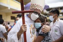 Newly ordained Bishop Miguel Angel Cadenas of Iquitos, Peru, embraces Ligia Saboya, who coordinates the Catholic community in her small village of Reforma on the Urituyacu River in Peru's northeastern Loreto region. (Ginebra Peña)